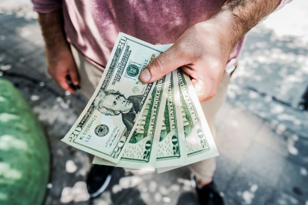 Man standing and handing out money