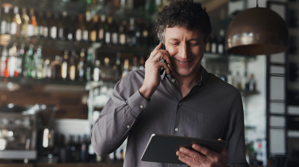 restaurant owner reviewing supply orders on tablet