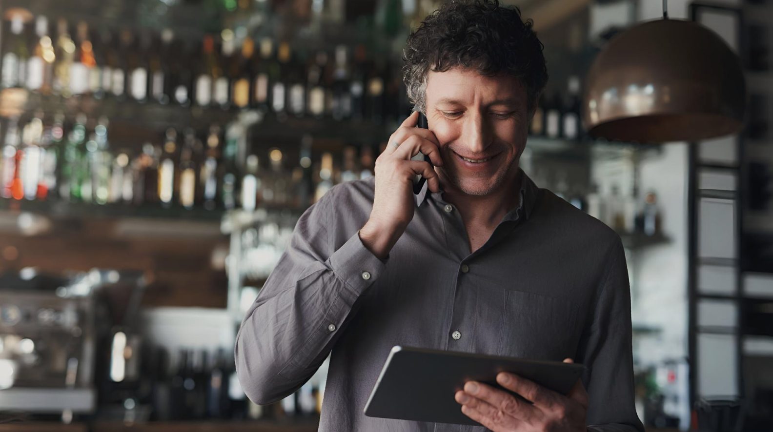 restaurant owner reviewing supply orders on tablet