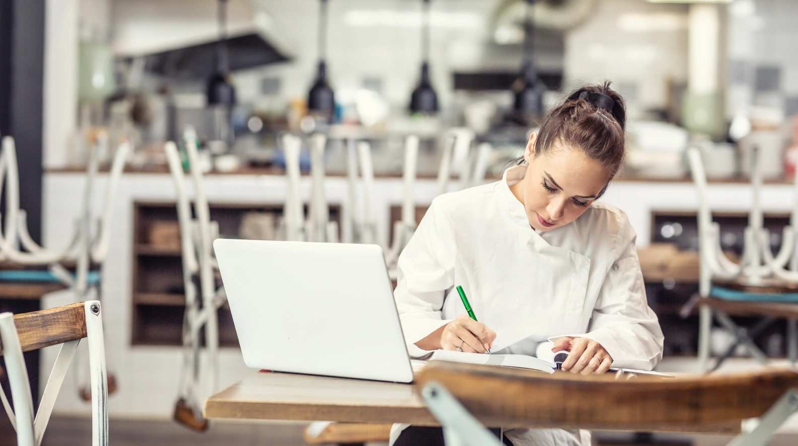 Independent restaurant operator reviewing restaurant procurement and inventory planning at a laptop